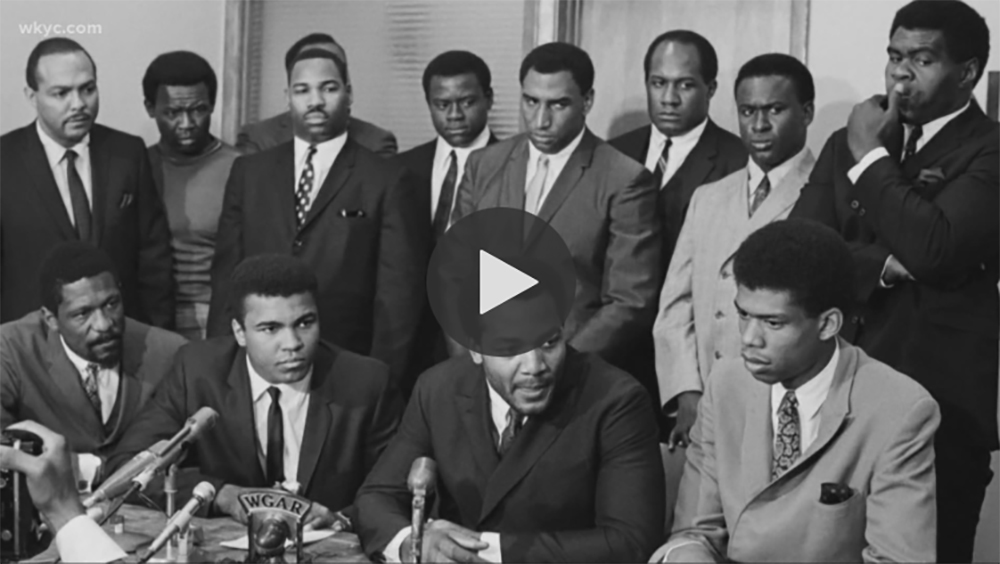 Nation's top African-American athletes gathered for a meeting at the Negro Industrial and Economic Union to hear Cassius Clay's view for rejecting Army induction. News conference shows (front row) Bill Russell, Boston Celtics; Cassius Clay; Jim Brown and Lew Alcindor. Back row (left to right): Carl Stokes, Democratic State Rep.; Walter Beach, Cleveland Browns; Bobby Mitchell, Washington Redskins; Sid Williams, Cleveland Browns; Curtis McClinton, Kansas City Chiefs; Willie Davis, Green Bay Packers; Jim Shorter, former Brown and John Wooten, Cleveland Browns.